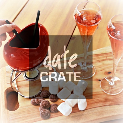 Items from a Date Crate subscription box including 2 alcoholic drinks and a fondue pot with chocolate and marshmallows.