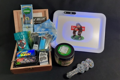 A Stoner Bundle subscription box filled with organic hemp wraps, lighters, CBD gummies, and a Rick and Morty tray.