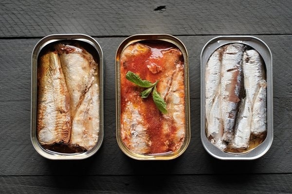 3 open tins of tinned fish from a Tinned Fish Club subscription box.