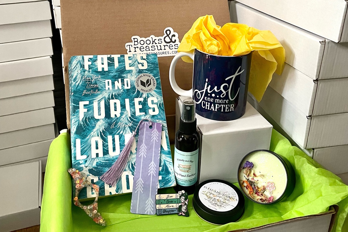 April’s books & treasures box. A box with one used book, handmade gifts, and a handmade bookmark. Room spray, candle, page holder, and pin. 