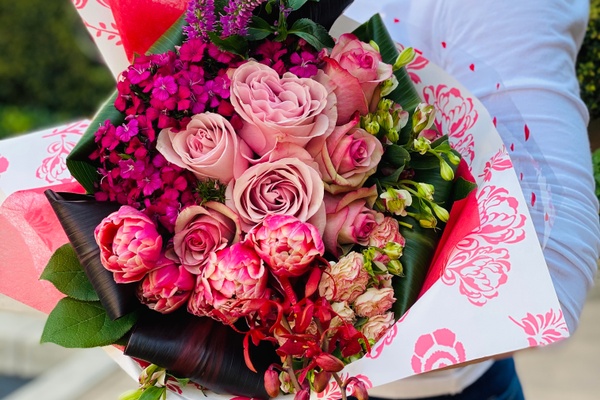 A bouquet of roses and other flowers in all shades of pink.