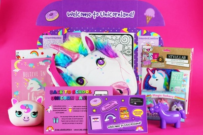 A Unicorn Dream subscription box with various unicorn toys, coloring books and stickers.
