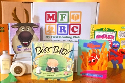 A My First Reading Club subscription box surrounded by a Sven toy, a Boss Baby book, a Finding Nemo book and more.