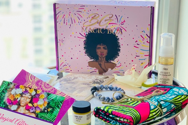 A Black Girl Magic subscription box with self-care items such as body washes, a bracelet, a colorful towel and more.