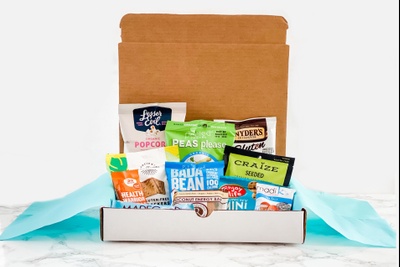 HealthyMe Living Snack Box subscription filled with Bada Bean, Craize seeds, popcorn, dried peas and other healthy snacks.