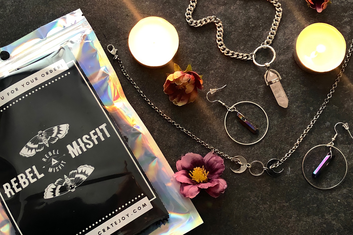 Items from a Rebel Misfits subscription box, including necklaces and earrings.
