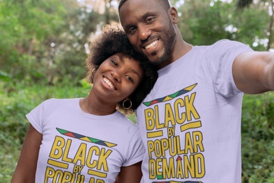 A couple wearing matching T-shirts that say Black by Popular Demand.