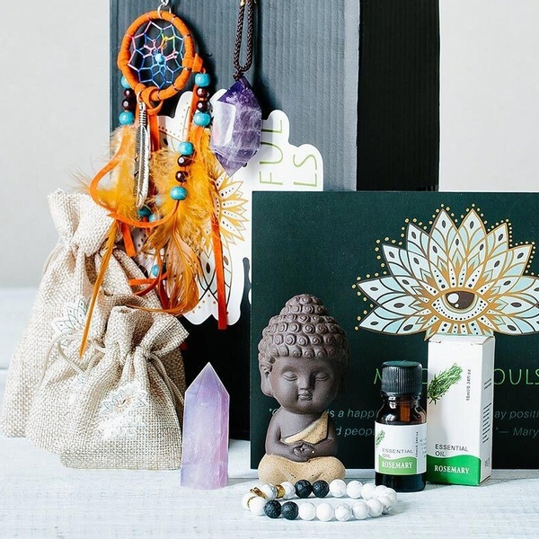 A Mindful Box subscription box with a little figure, a bracelet, an amethyst crystal, a dream catcher, a necklace around it.