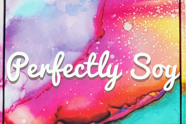 The top of a Perfectly Soy subscription box that looks like a colorful water color painting.