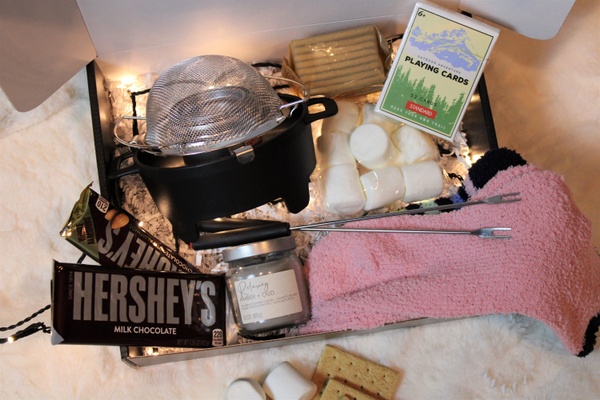 Items from a Krush Date Night subscription box, including Hershey's bars, marshmallows, graham crackers and fondue pot.