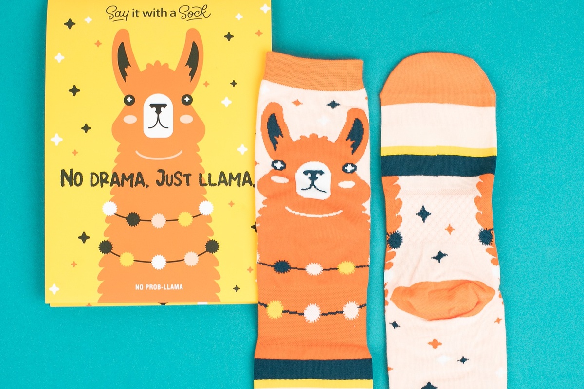 A Say it With A Sock subscription box with the words No Drama, Just Llama and a pair of llama socks.