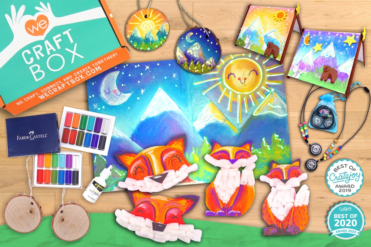 A closed We Craft subscription box with crayons, glue, fox crafts, a mountain scene and other crafts.