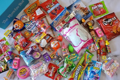 The Munchie Box subscription box with Cheetos, fruit snacks, fun dip, cotton candy, skittles and other snacks and candy.