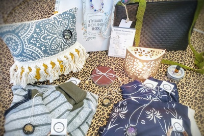 Items from The Appalachian Artisan subscription box including a decorative pillow, necklaces, women's clothing and more.