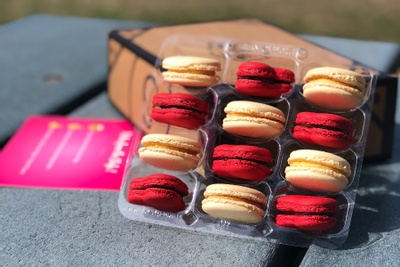 A tray of red and yellow macarons from a Macaron subscription box.