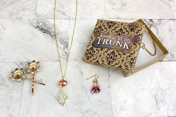 Items from a Junque in They Trunk subscription box including hair pins, earrings and a necklace.