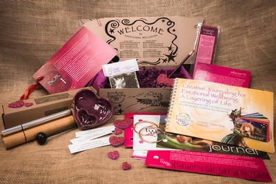 An emotional well being subscription box showing something for each of your senses to delight and support you.