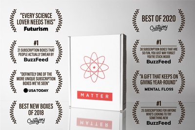 A closed, white Matter subscription box with an atom symbol on it. There are awards and positive reviews all around it.