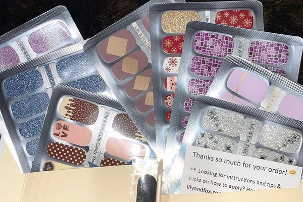 Several packs of various colors and designs of nail stickers from a Polish Pack subscription box.