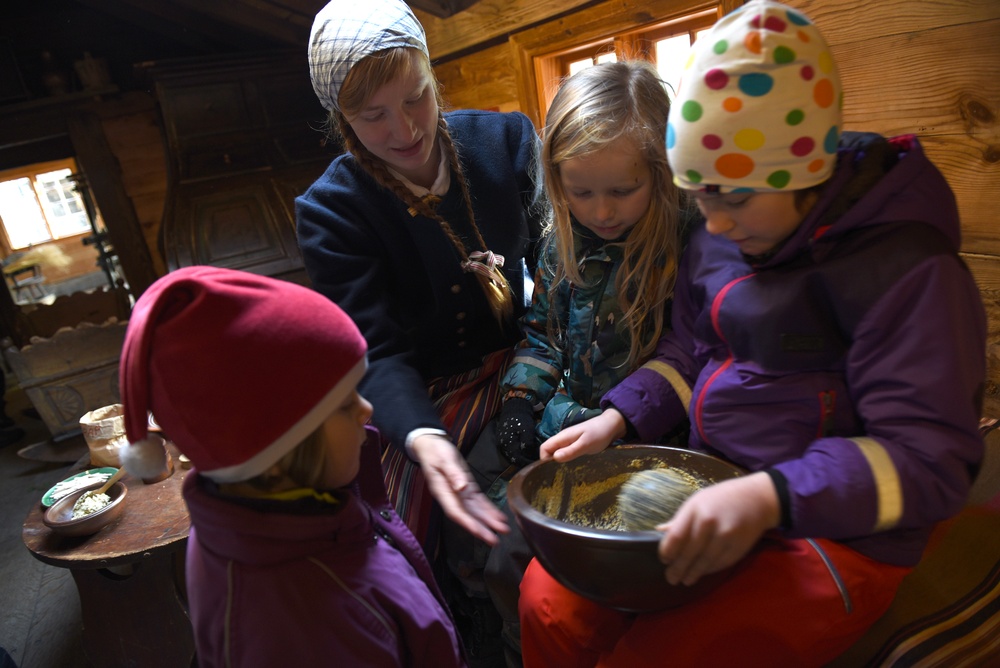 Besökande barn provar att mala senap med kanonkula i Blekingegården på Kulturen i Lund. Foto: Nelly Hercberg. Kulturen