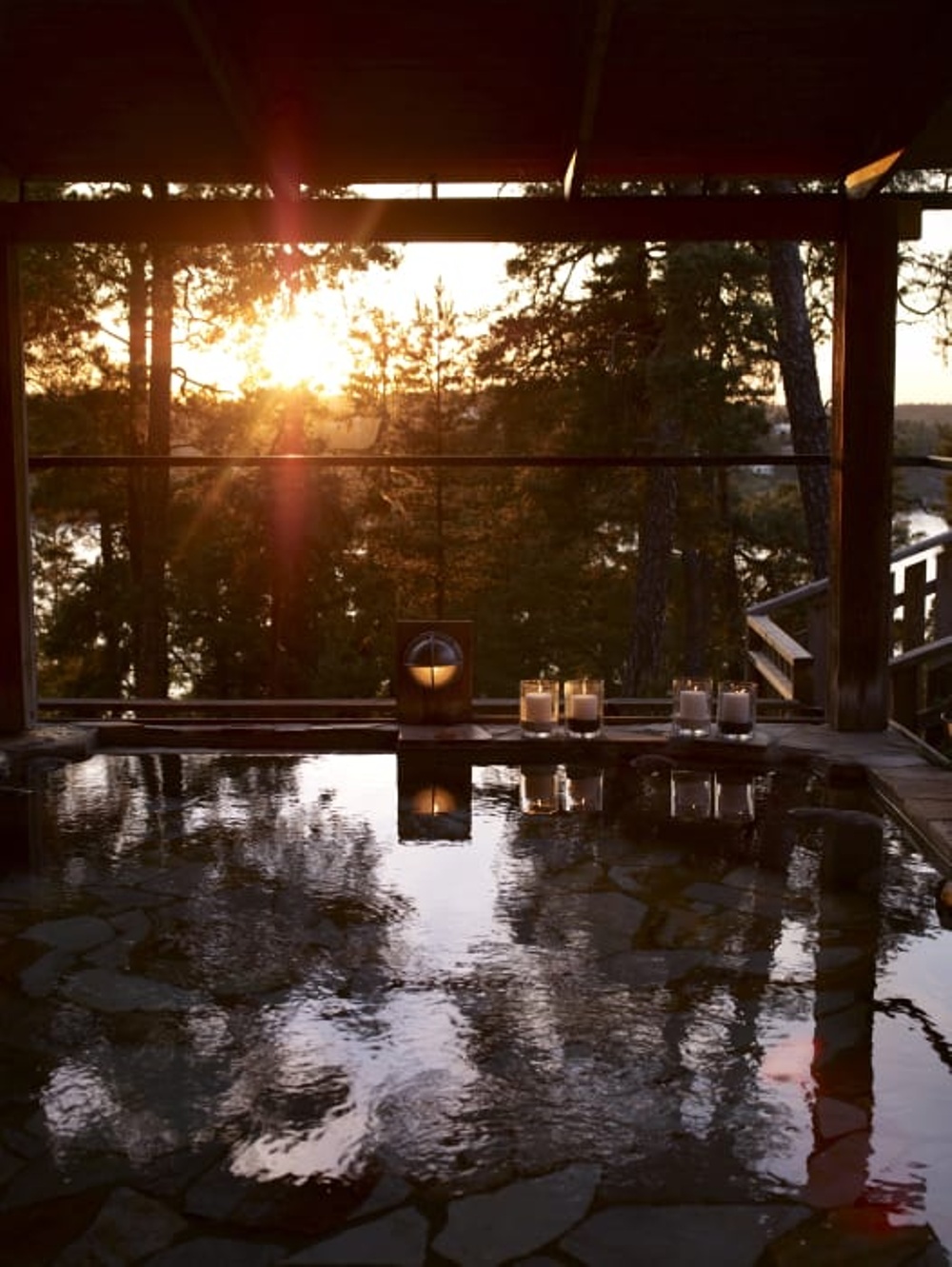 A summer sunset and a Japanese hot water bath with surrounding soft candlelights.