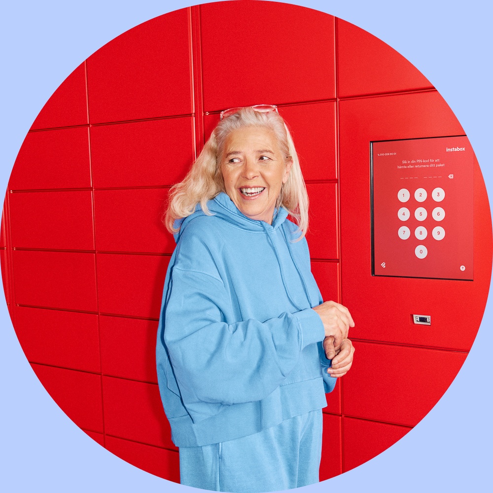 The consumer is picking up a parcel at a red Instabox parcel locker. 