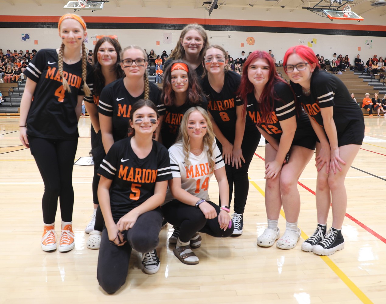 The girls JV volleyball team poses for a photo at the pep assembly