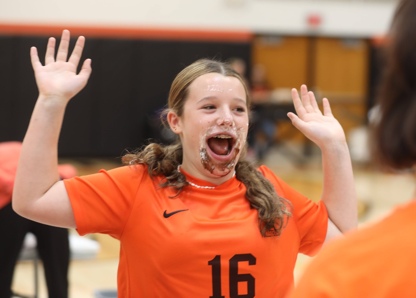 The winner celebrates after repeating as pudding eating contest champion