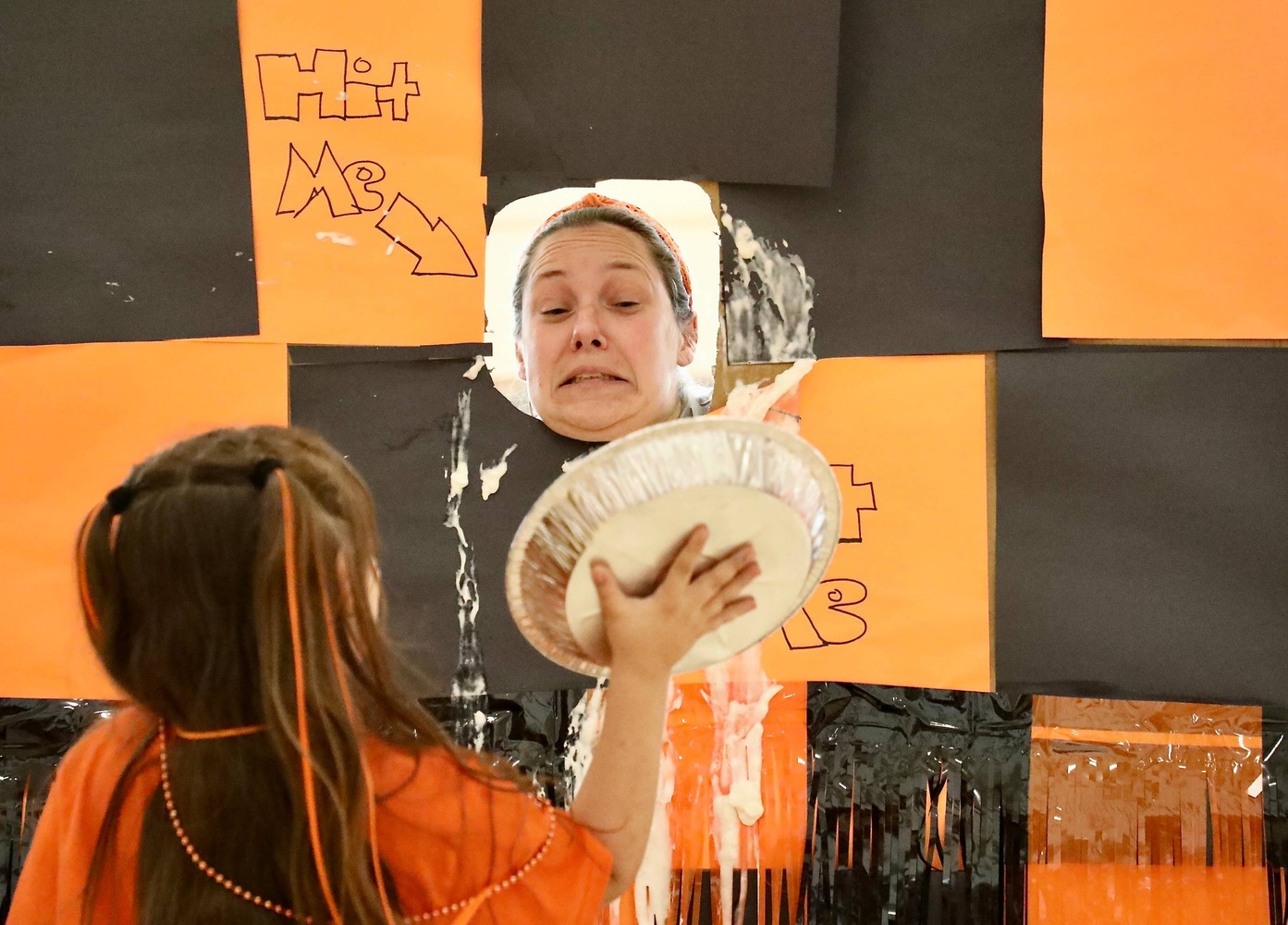 A staff member prepares to receive a pie to the face