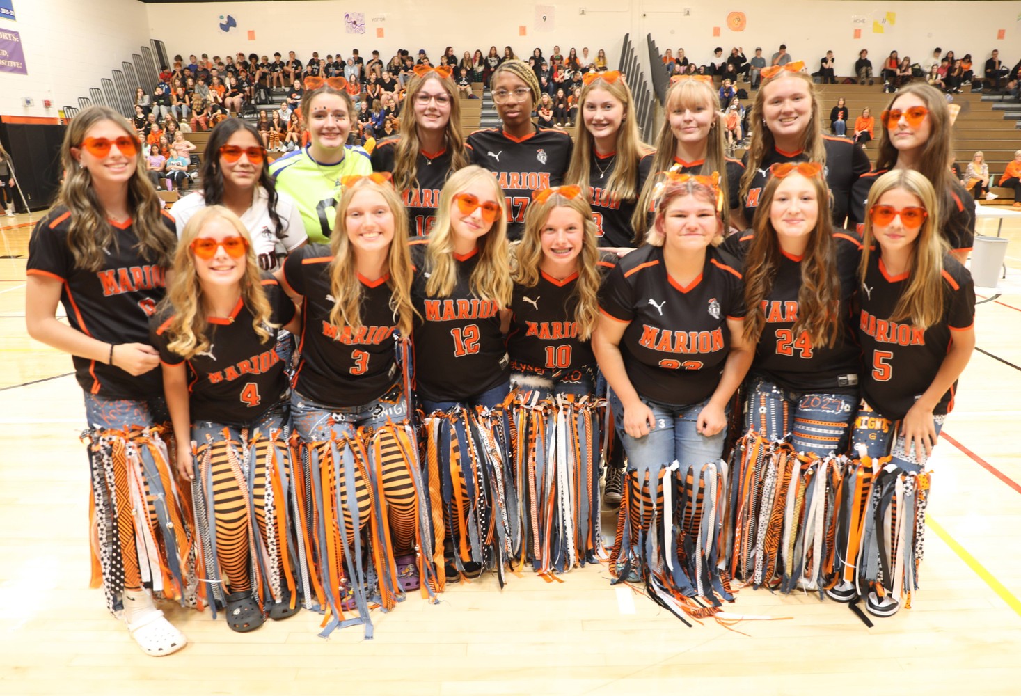 The girls varsity soccer team poses for a photo at the pep assembly 