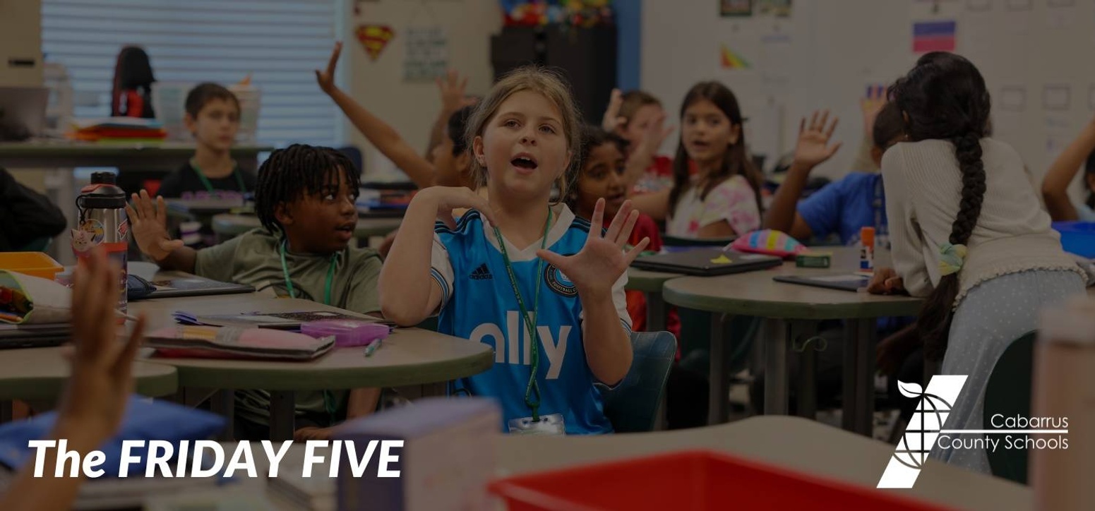 A student holding up five fingers.