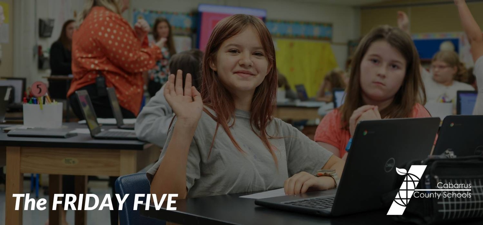 A student holding up five fingers.