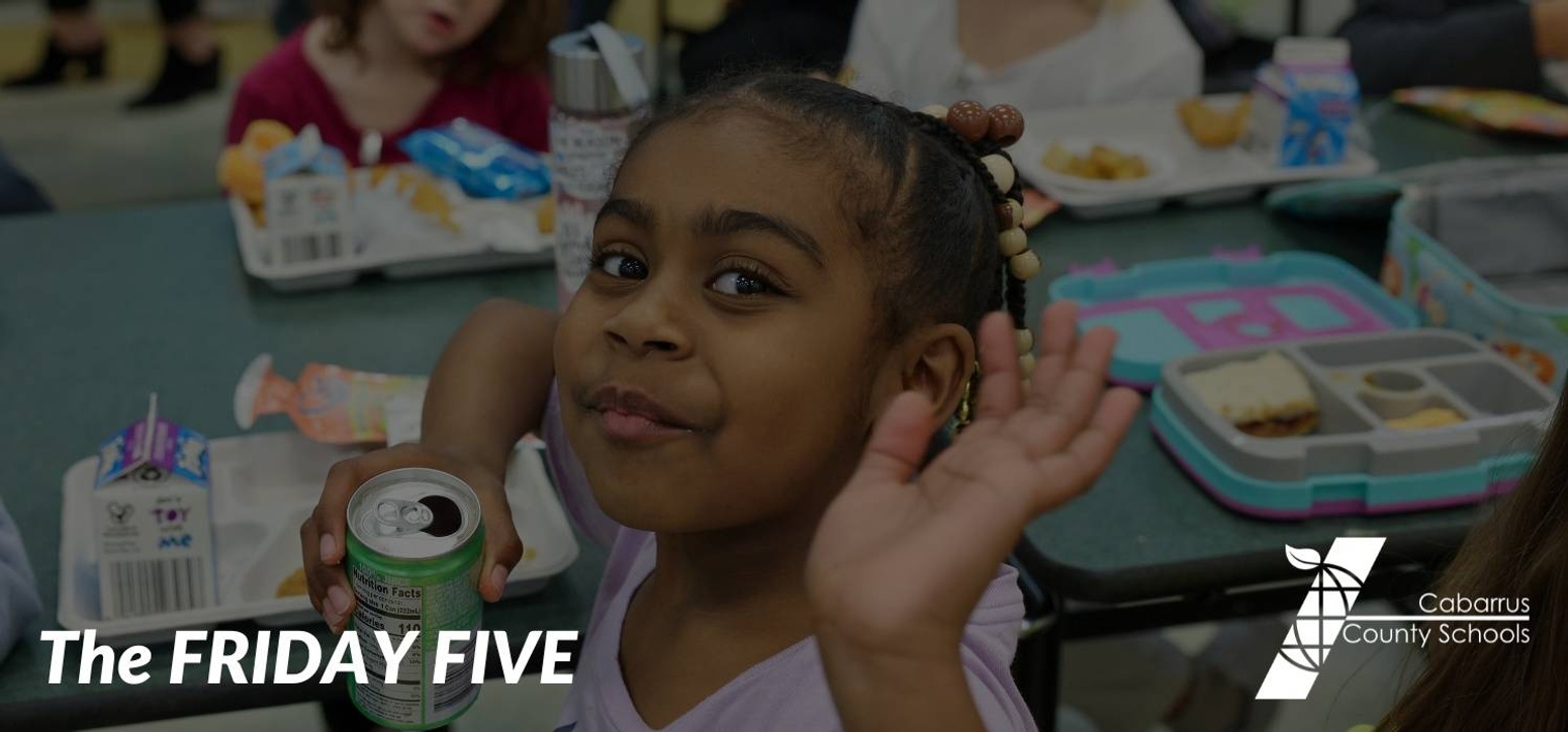 A student holding up five fingers.