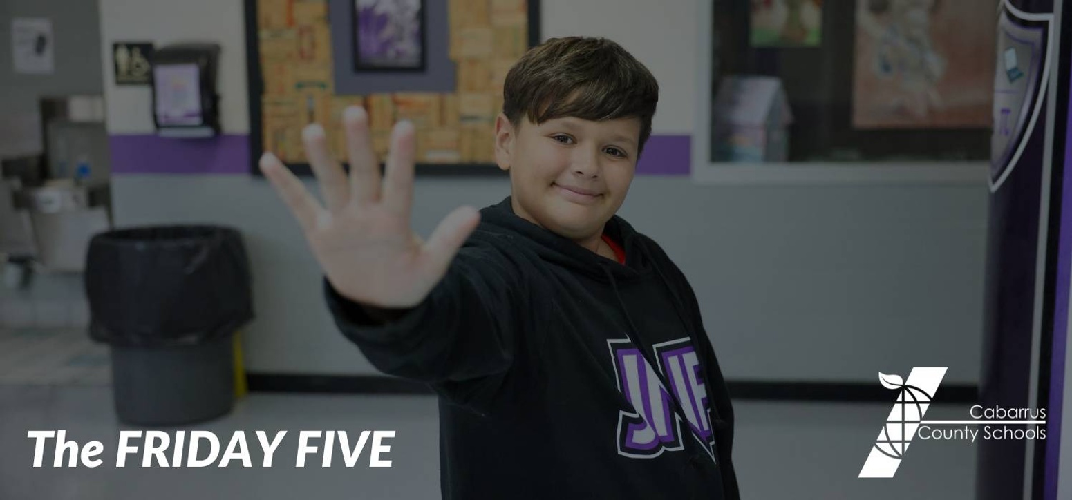 A student holding up five fingers.