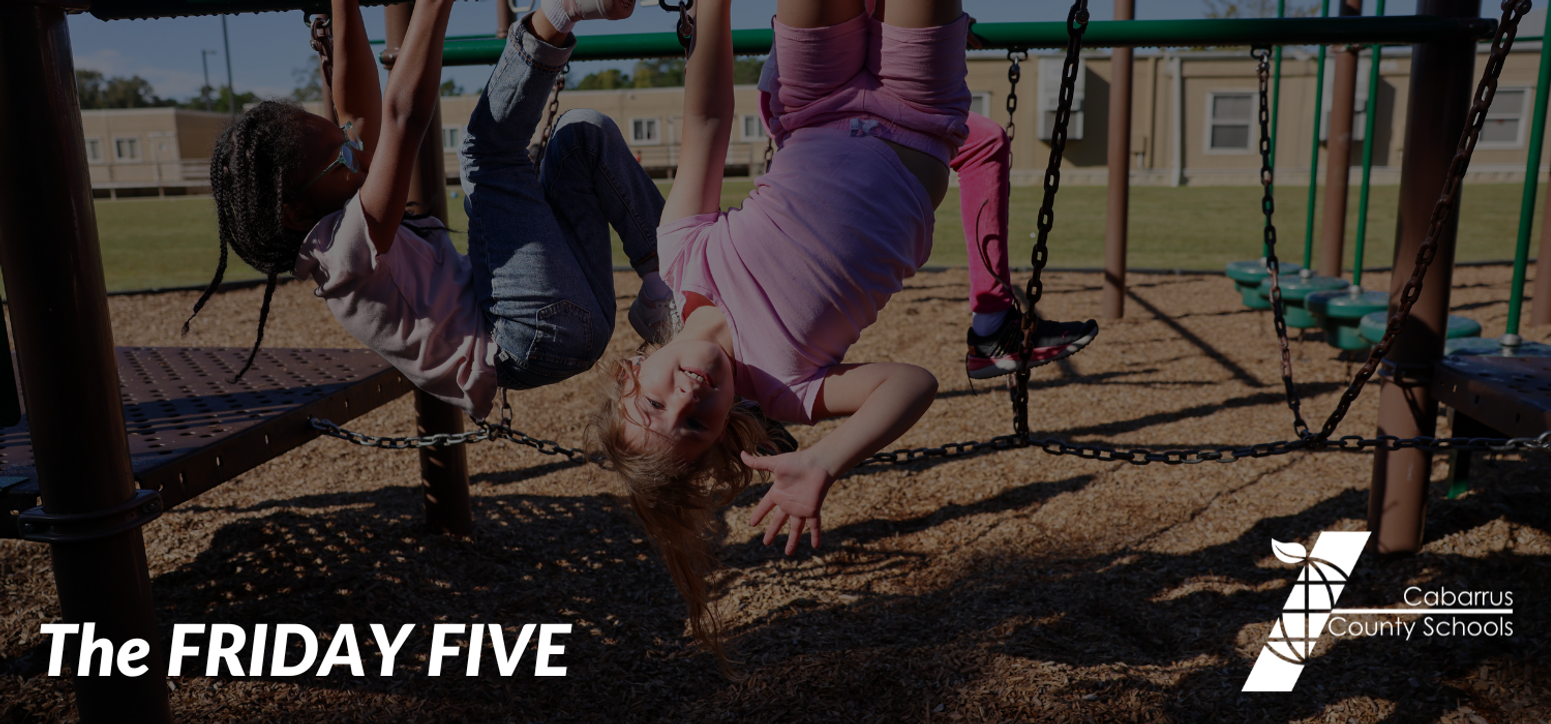 A student holding up five fingers.