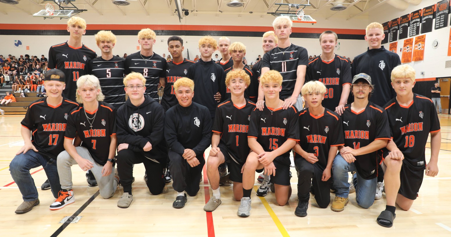 The boys varsity soccer team poses for a photo at the pep assembly 