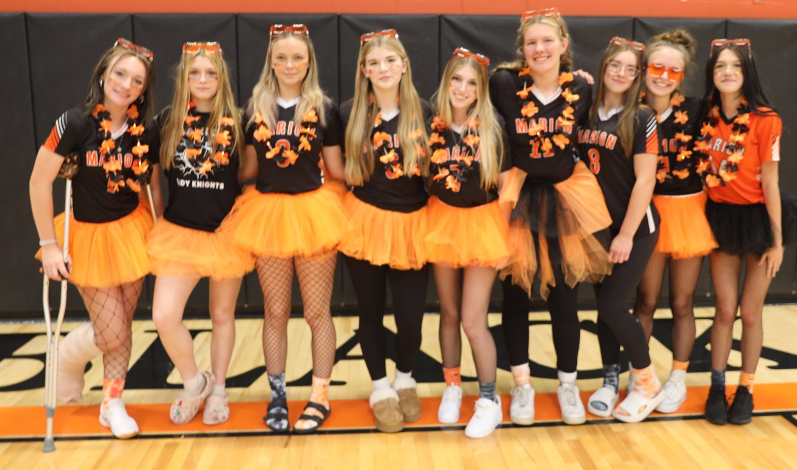 The girls varsity volleyball team poses for a photo at the pep assembly 