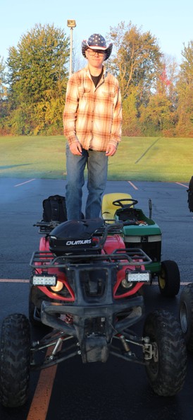 A student stands on a four-wheeler