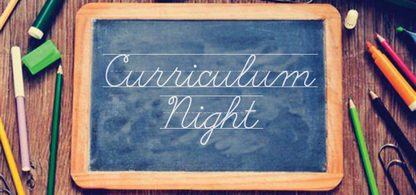 Chalkboard with curriculum night written in chalk, surrounded by pens, markers, pencils, paper clips