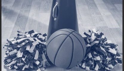 Basketball with poms-poms and cheer horn on gym floor.