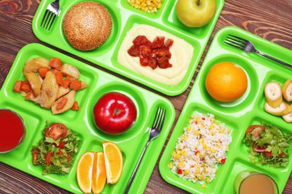 green school lunch trays with food