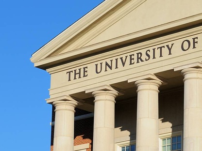 University building with Greek columns against a blue sky.