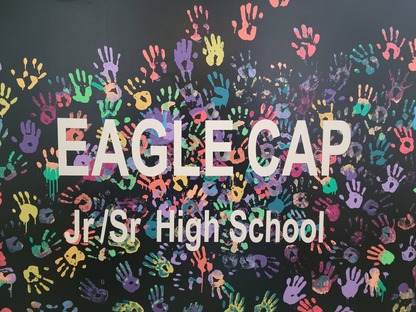 Eagle Cap sign with paint handprints