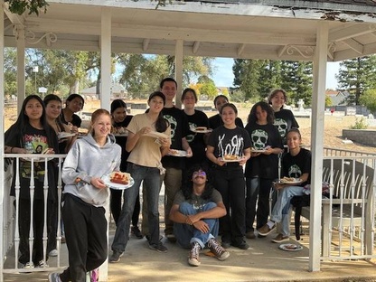 A group of students pose outside in a gazebo