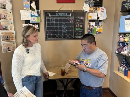 Trustee Lowe talked with a patron at coffee shop