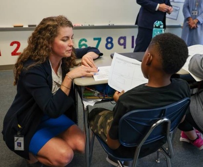 Dr. Johanna Parker, Assistant Superintendent of Elementary Schools, discusses classwork with a student at Bethel Elementary School.