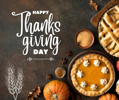 A cozy Thanksgiving display of pies, pumpkins, and autumn produce arranged beautifully on a dark surface. The text reads "Happy Thanksgiving Day."