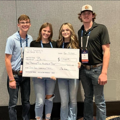 4 students holding their big check