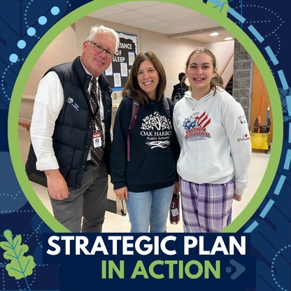 A man and two women stand together in a school hallway, smiling for a photo. The text 'Strategic Plan in Action' is visible in the foreground.