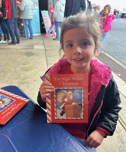 1 person holds book